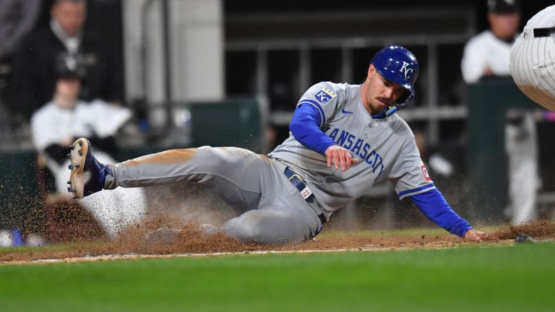 Apr 15, 2024; Chicago, Illinois, USA; Kansas City Royals designated hitter Nick Loftin (12) slides in to score during the fifth inning against the Chicago White Sox at Guaranteed Rate Field. Mandatory Credit: Patrick Gorski-USA TODAY Sports