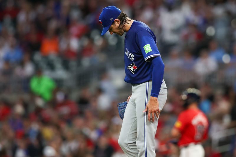 Sep 6, 2024; Atlanta, Georgia, USA; Toronto Blue Jays starting pitcher Kevin Gausman (34) reacts after giving up a walk against the Atlanta Braves in the second inning at Truist Park. Mandatory Credit: Brett Davis-Imagn Images