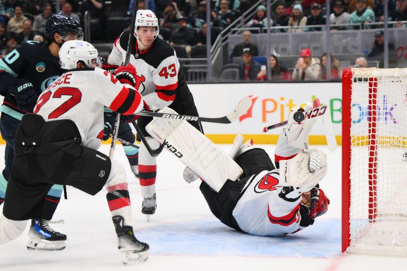Jan 6, 2025; Seattle, Washington, USA; New Jersey Devils goaltender Jacob Markstrom (25) blocks a goal shot against the Seattle Kraken during the third period at Climate Pledge Arena. Mandatory Credit: Steven Bisig-Imagn Images