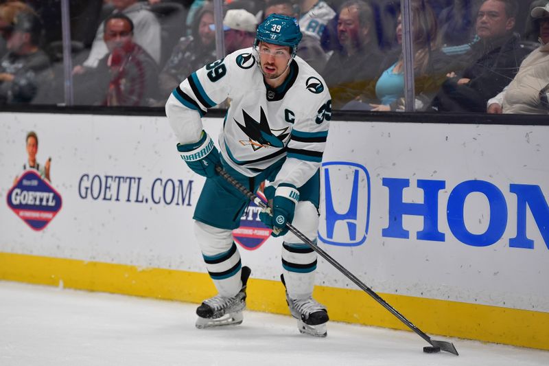 Jan 31, 2024; Anaheim, California, USA; San Jose Sharks center Logan Couture (39) controls the puck during the third period at Honda Center. Mandatory Credit: Gary A. Vasquez-USA TODAY Sports