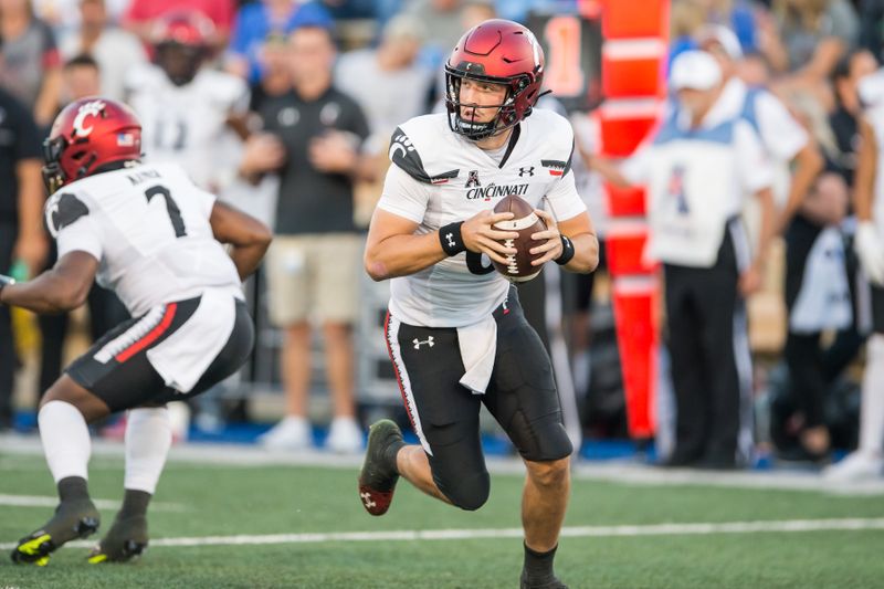 Oct 1, 2022; Tulsa, Oklahoma, USA;  Cincinnati Bearcats quarterback Ben Bryant (6) rolls out to pass during the first quarter against the Tulsa Golden Hurricane at Skelly Field at H.A. Chapman Stadium. Mandatory Credit: Brett Rojo-USA TODAY Sports