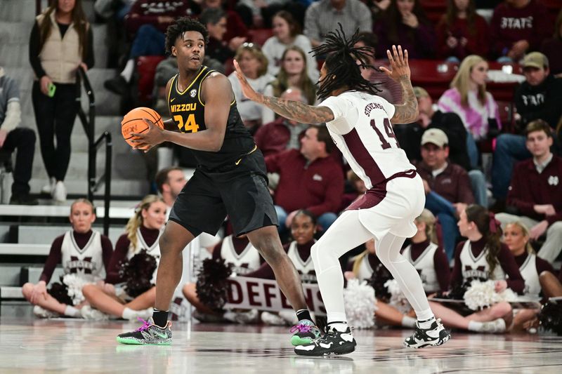 Feb 4, 2023; Starkville, Mississippi, USA; Missouri Tigers guard Kobe Brown (24) controls the ball against Mississippi State Bulldogs forward Tyler Stevenson (14) during the second half at Humphrey Coliseum. Mandatory Credit: Matt Bush-USA TODAY Sports