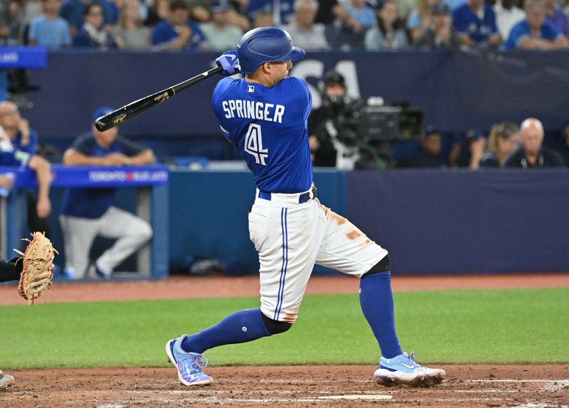 Aug 26, 2023; Toronto, Ontario, CAN;  Toronto Blue Jays right fielder George Springer (4) hits a double against the Cleveland Guardians in the seventh inning at Rogers Centre. Mandatory Credit: Dan Hamilton-USA TODAY Sports