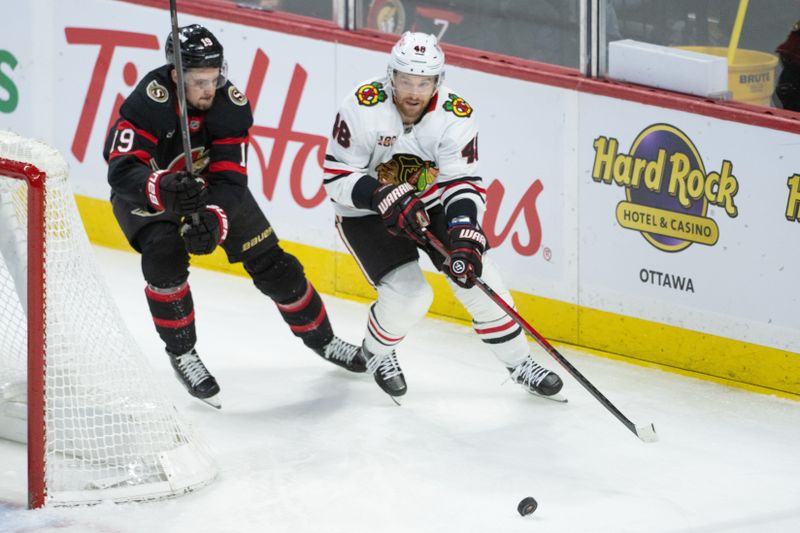 Dec 20, 2025; Ottawa, Ontario, CAN; Ottawa Senators right wing Drake Batherson (19) and Chicago Blackhawks defenseman Matthew Grzelcyk (48) chase the puck in the third period at the Canadian Tire Centre. Mandatory Credit: Marc DesRosiers-IMAGN Images