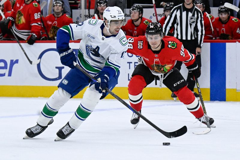 Oct 17, 2025; Chicago, Illinois, USA;  Vancouver Canucks center Filip Chytil (72) and Chicago Blackhawks center Connor Bedard (98) chase the puck during the first period at the United Center. Mandatory Credit: Matt Marton-Imagn Images