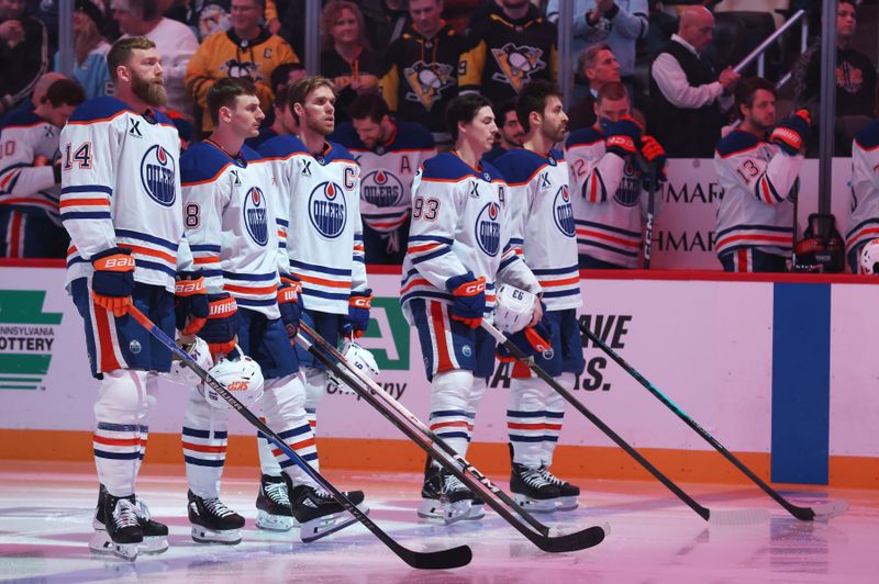 Dec 16, 2025; Pittsburgh, Pennsylvania, USA; The Edmonton Oilers starting line-up consisting of (L to R) defenseman Mattias Ekholm (14), left wing Zach Hyman (18), center Connor McDavid (97), right wing Ryan Nugent-Hopkins (93) and defenseman Evan Bouchard (2) stand for the national anthem against the Pittsburgh Penguins at PPG Paints Arena. Mandatory Credit: Charles LeClaire-Imagn Images