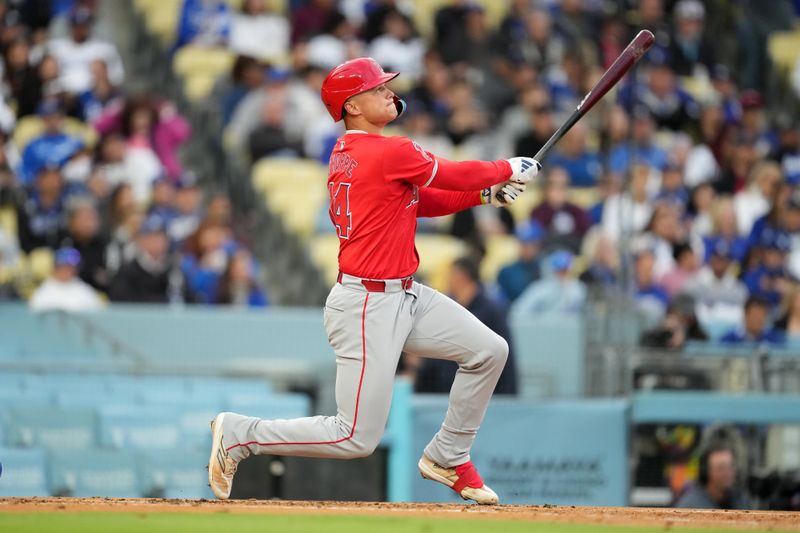 Mar 25, 2024; Los Angeles, California, USA; Los Angeles Angels catcher Logan O'Hoppe (14) follows through on a three-run home run in the second inning against the Los Angeles Dodgers at Dodger Stadium. Mandatory Credit: Kirby Lee-USA TODAY Sports