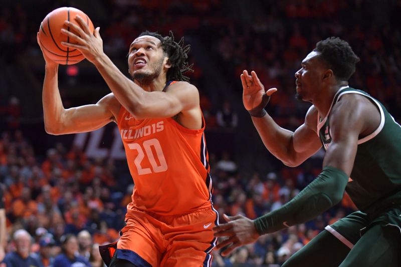 Jan 11, 2024; Champaign, Illinois, USA;  Illinois Fighting Illini forward Ty Rodgers (20) drives to the basket as Michigan State Spartans center Mady Sissoko (22) defends during the first half at State Farm Center. Mandatory Credit: Ron Johnson-USA TODAY Sports