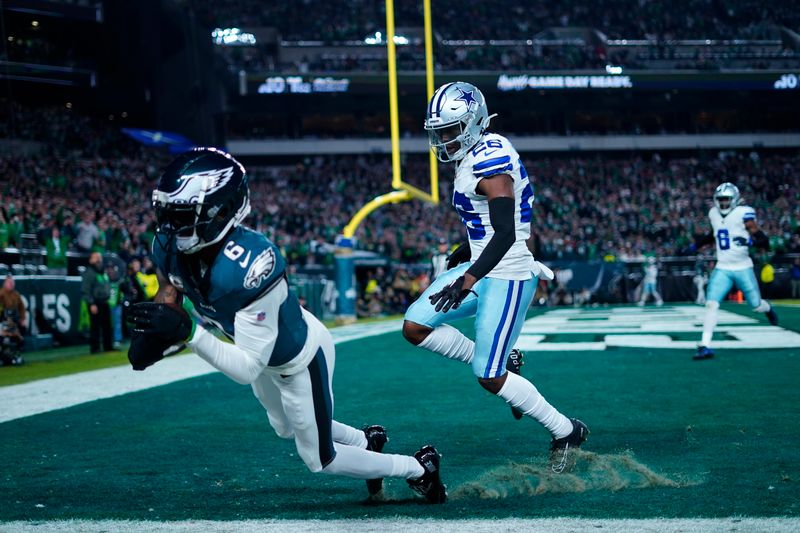 Philadelphia Eagles wide receiver DeVonta Smith (6) scores a touchdown in front of Dallas Cowboys cornerback DaRon Bland (26) during the second half of an NFL football game Sunday, Nov. 5, 2023, in Philadelphia. (AP Photo/Matt Rourke)