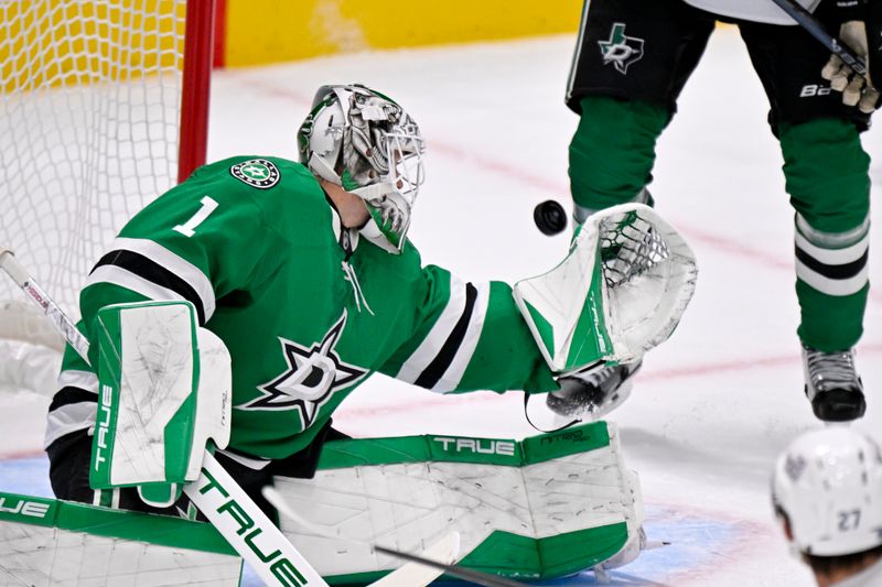 Nov 9, 2025; Dallas, Texas, USA; Dallas Stars goaltender Casey Desmith (1) attempts to make a glove save on a Seattle Kraken shot during the second period at the American Airlines Center. Mandatory Credit: Jerome Miron-Imagn Images