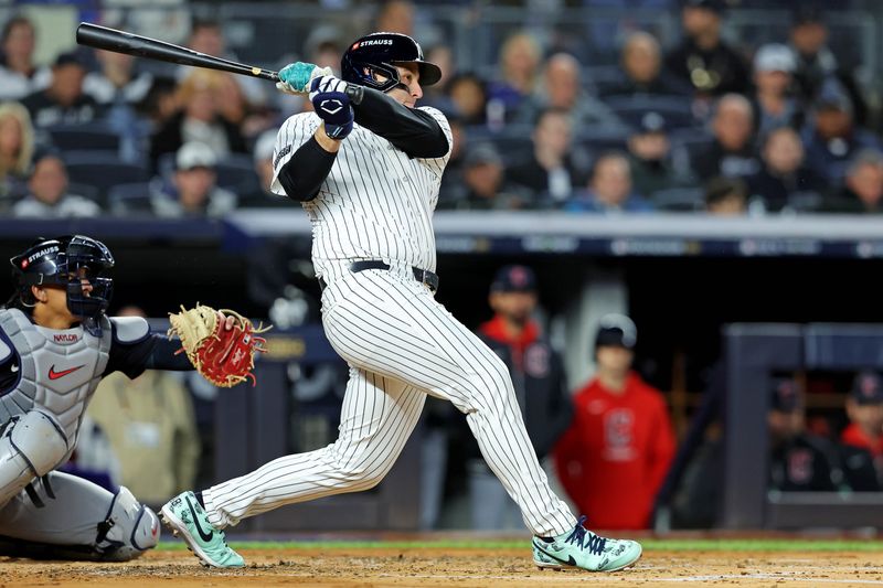 Oct 14, 2024; Bronx, New York, USA; New York Yankees first base Anthony Rizzo (48) hits a single during the second inning against the Cleveland Guardians in game one of the ALCS for the 2024 MLB Playoffs at Yankee Stadium. Mandatory Credit: Brad Penner-Imagn Images