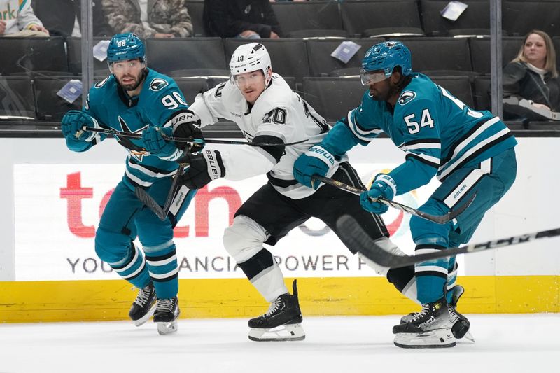 Nov 25, 2024; San Jose, California, USA; San Jose Sharks defenseman Jake Walman (96), Los Angeles Kings left winger Tanner Jeannot (10), and right wing Givani Smith (54) race to the puck in the first period at SAP Center at San Jose. Mandatory Credit: David Gonzales-Imagn Images