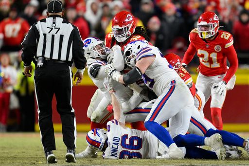 Buffalo Bills quarterback Josh Allen, with ball, is stopped on a fourth down attempt by Kansas City Chiefs linebacker Nick Bolton (32) and teammates during the second half of the NFL AFC Championship football game, Sunday, Jan. 26, 2025 in Kansas City, Mo. The Chiefs defeated the Bills by a score of 32-29. (AP Photo/Reed Hoffmann)