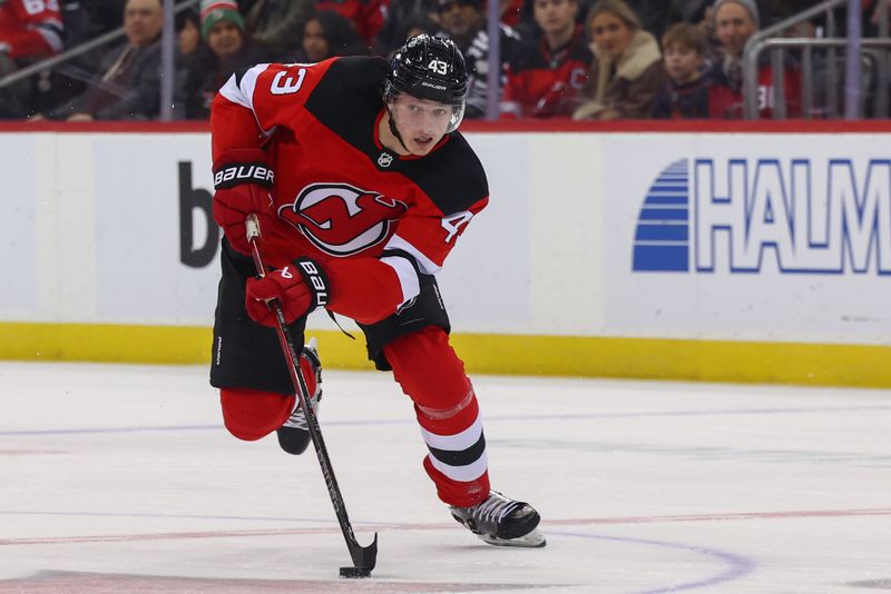 Dec 21, 2023; Newark, New Jersey, USA; New Jersey Devils defenseman Luke Hughes (43) skates with the puck against the Edmonton Oilers during the second period at Prudential Center. Mandatory Credit: Ed Mulholland-USA TODAY Sports