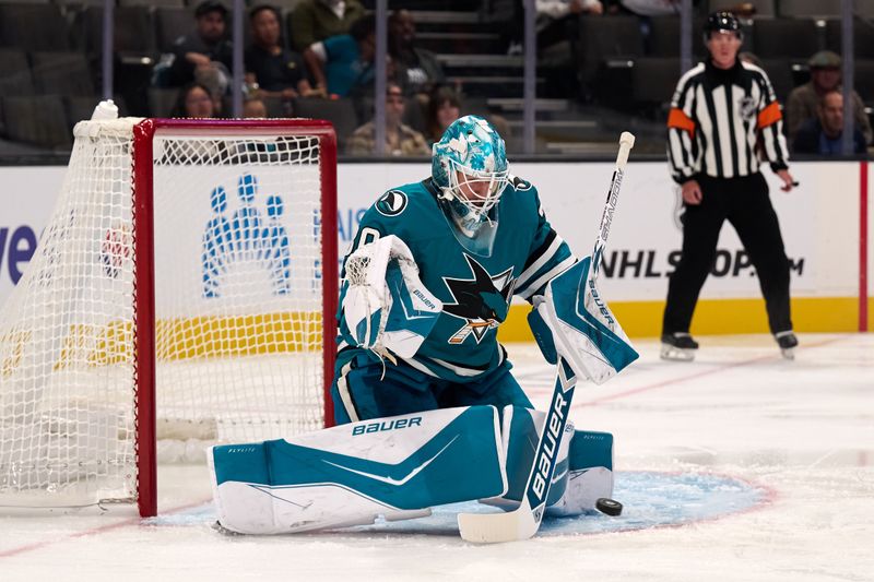 Oct 1, 2025; San Jose, California, USA; San Jose Sharks goaltender Yaroslav Askarov (30) makes a save against the Anaheim Ducks during the first period at SAP Center at San Jose. Mandatory Credit: Robert Edwards-Imagn Images