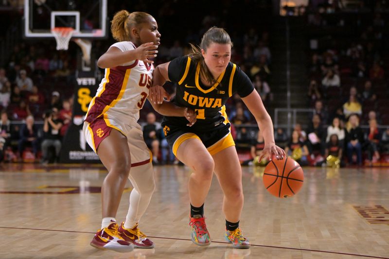 Jan 29, 2026; Los Angeles, California, USA;  Iowa Hawkeyes guard Taylor Stremlow (1) drives past USC Trojans guard Londynn Jones (3) in the second half at Galen Center. Mandatory Credit: Jayne Kamin-Oncea-Imagn Images
