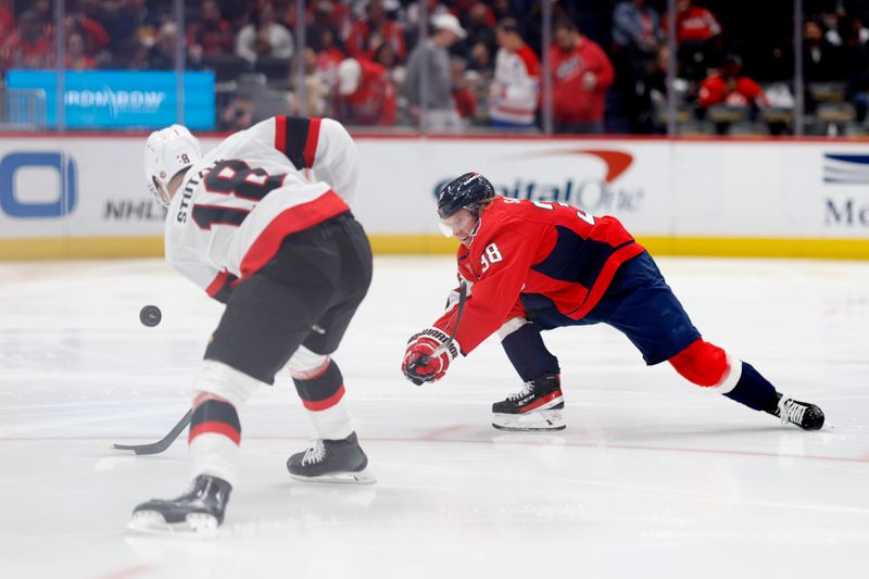 Feb 26, 2024; Washington, District of Columbia, USA; Washington Capitals defenseman Rasmus Sandin (38) blocks a pass by Ottawa Senators center Tim Stutzle (18) in the second period at Capital One Arena. Mandatory Credit: Geoff Burke-USA TODAY Sports