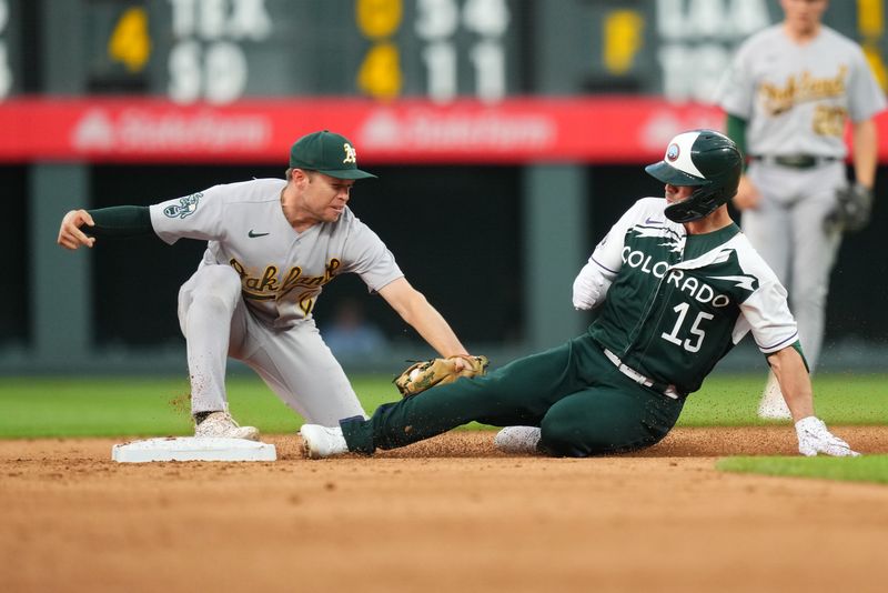 Jul 29, 2023; Denver, Colorado, USA; Oakland Athletics shortstop Nick Allen (2) tags out Colorado Rockies right fielder Randal Grichuk (15) on a steal attempt in the fifth inning at Coors Field. Mandatory Credit: Ron Chenoy-USA TODAY Sports