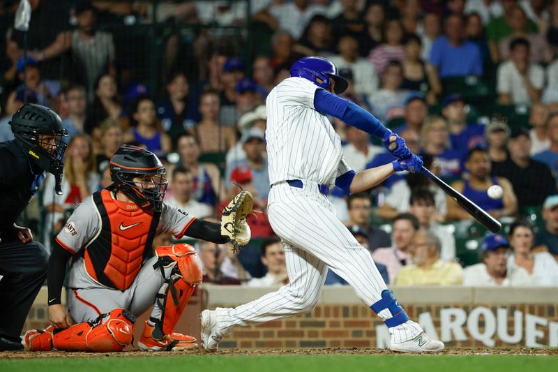 Jun 17, 2024; Chicago, Illinois, USA; Chicago Cubs first baseman Michael Busch (29) hits a two-run home run against the San Francisco Giants during the sixth inning at Wrigley Field. Mandatory Credit: Kamil Krzaczynski-USA TODAY Sports