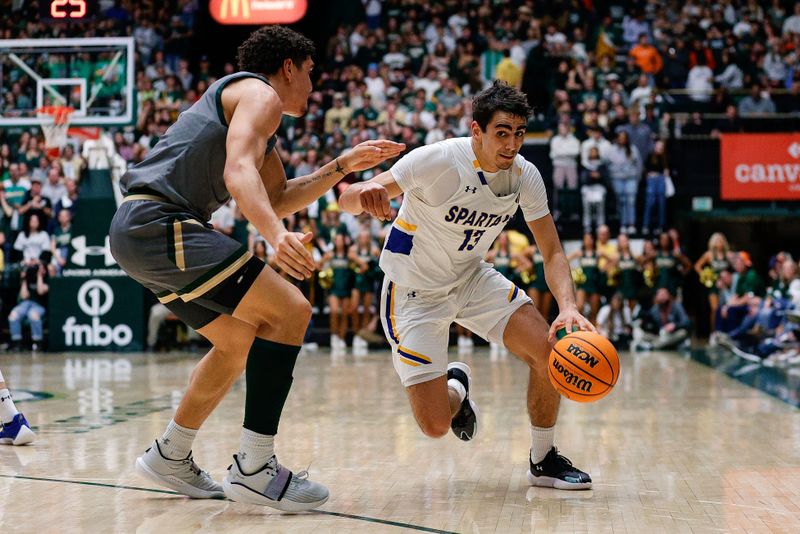 Feb 9, 2024; Fort Collins, Colorado, USA; San Jose State Spartans guard Alvaro Cardenas (13) controls the ball as Colorado State Rams forward Joel Scott (1) guards in the first half at Moby Arena. Mandatory Credit: Isaiah J. Downing-USA TODAY Sports