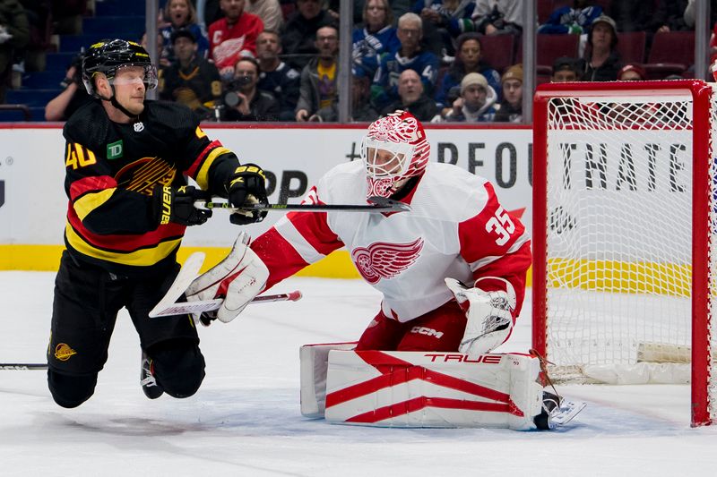 Feb 13, 2023; Vancouver, British Columbia, CAN; Vancouver Canucks forward Elias Pettersson (40) collides with Detroit Red Wings goalie Ville Husso (35) in the first period at Rogers Arena. Mandatory Credit: Bob Frid-USA TODAY Sports