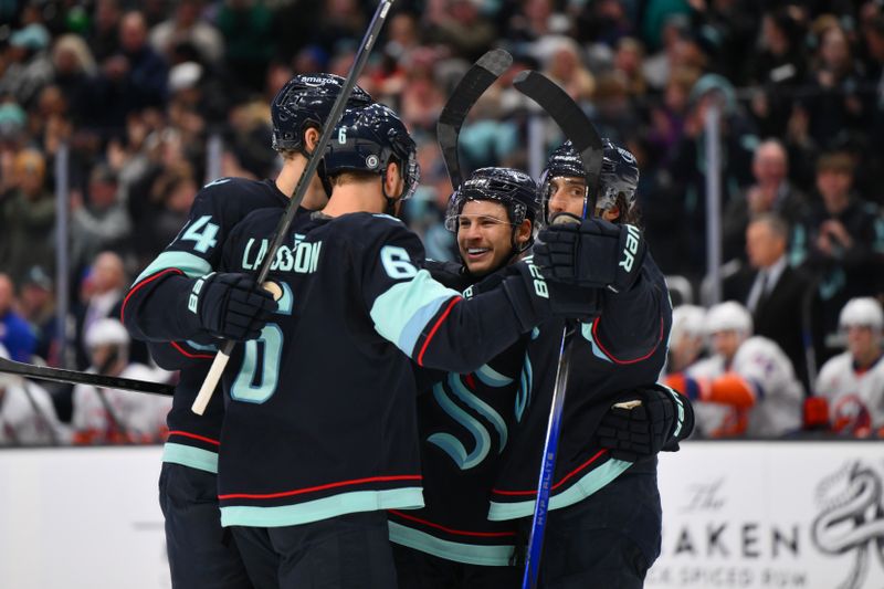 Nov 16, 2024; Seattle, Washington, USA; The Seattle Kraken celebrate after a goal scored by defenseman Jamie Oleksiak (24) during the third period against the New York Islanders at Climate Pledge Arena. Mandatory Credit: Steven Bisig-Imagn Images