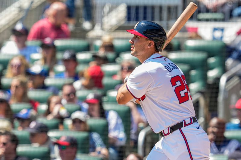 Apr 7, 2024; Cumberland, Georgia, USA; Atlanta Braves first baseman Matt Olson (28) hits a home run against the Arizona Diamondbacks during the second inning at Truist Park. Mandatory Credit: Dale Zanine-USA TODAY Sports