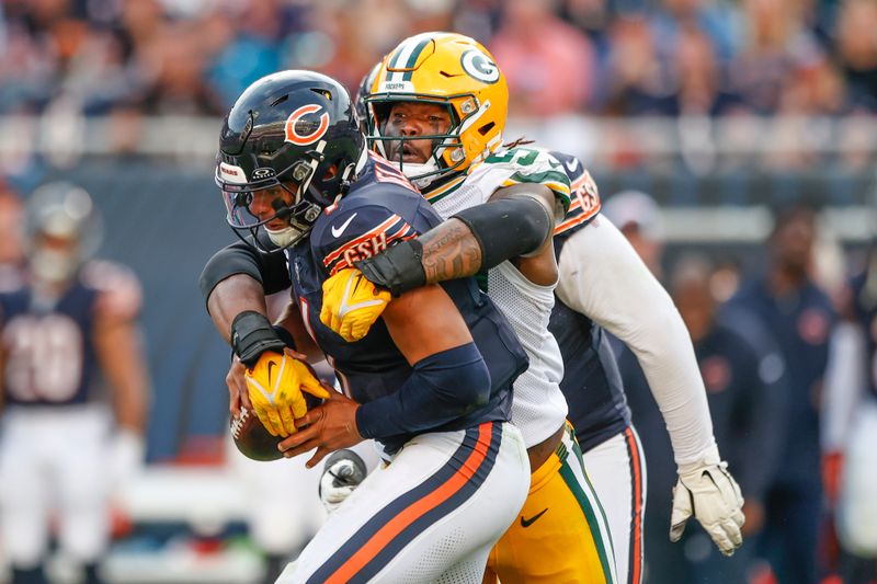 Chicago Bears quarterback Justin Fields (1) is tackled by Green Bay Packers linebacker Rashan Gary (52)during the second half of an NFL football game, Sunday, Sept. 10, 2023, in Chicago. (AP Photo/Kamil Krzaczynski)