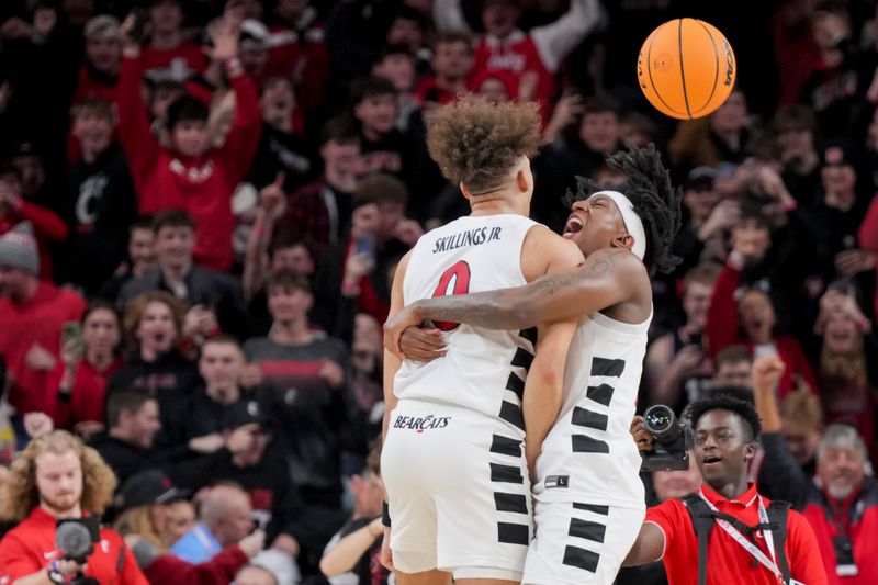 Jan 16, 2024; Cincinnati, Ohio, USA;  Cincinnati Bearcats guard Dan Skillings Jr., left, celebrates with guard Rayvon Griffith after defeating the TCU Horned Frogs as time expires in overtime at Fifth Third Arena. Mandatory Credit: Aaron Doster-USA TODAY Sports