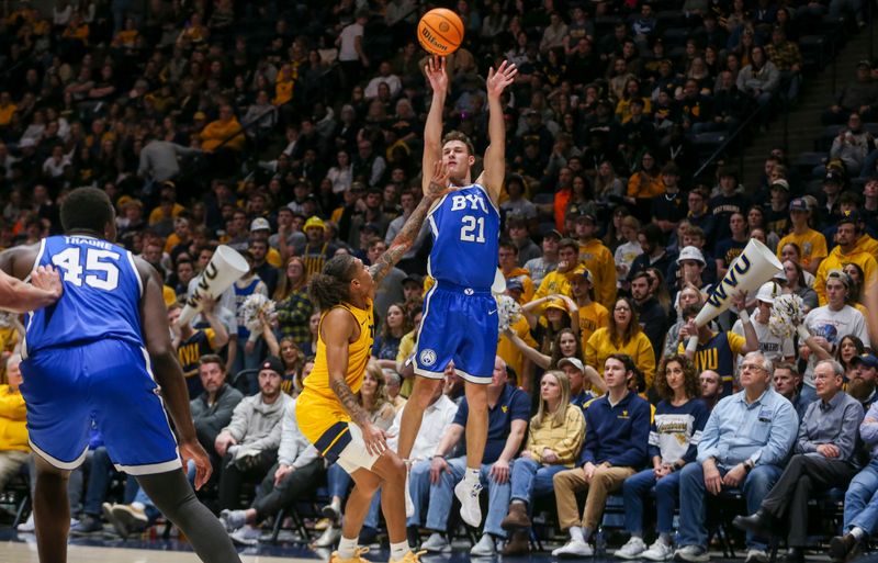 Feb 3, 2024; Morgantown, West Virginia, USA; Brigham Young Cougars guard Trevin Knell (21) shoots a three pointer during the first half against the West Virginia Mountaineers at WVU Coliseum. Mandatory Credit: Ben Queen-USA TODAY Sports