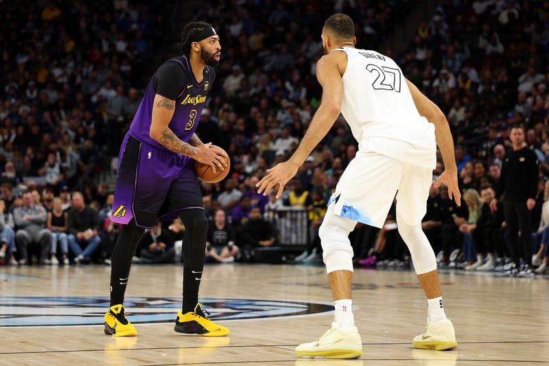 MINNEAPOLIS, MINNESOTA - DECEMBER 02: Anthony Davis #3 of the Los Angeles Lakers handles the ball against Rudy Gobert #27 of the Minnesota Timberwolves in the third quarter at Target Center on December 02, 2024 in Minneapolis, Minnesota. The Timberwolves defeated the Lakers 109-80. NOTE TO USER: User expressly acknowledges and agrees that, by downloading and or using this photograph, User is consenting to the terms and conditions of the Getty Images License Agreement. (Photo by David Berding/Getty Images)