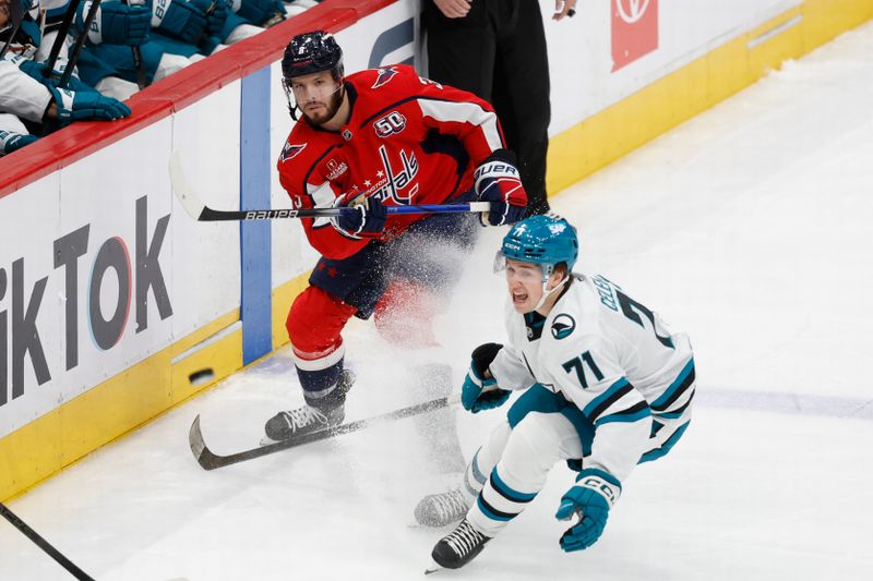 Dec 3, 2024; Washington, District of Columbia, USA; Washington Capitals defenseman Matt Roy (3) clears the puck in to the offensive zone past San Jose Sharks center Macklin Celebrini (71) in the first period at Capital One Arena. Mandatory Credit: Geoff Burke-Imagn Images