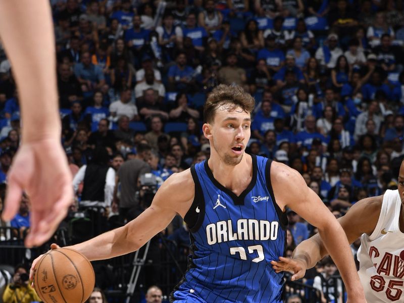 ORLANDO, FL - APRIL 27: Franz Wagner #22 of the Orlando Magic dribbles the ball during the game against the Cleveland Cavaliers during Round 1 Game 4 of the 2024 NBA Playoffs on April 27, 2024 at the Kia Center in Orlando, Florida. NOTE TO USER: User expressly acknowledges and agrees that, by downloading and or using this photograph, User is consenting to the terms and conditions of the Getty Images License Agreement. Mandatory Copyright Notice: Copyright 2024 NBAE (Photo by Fernando Medina/NBAE via Getty Images)