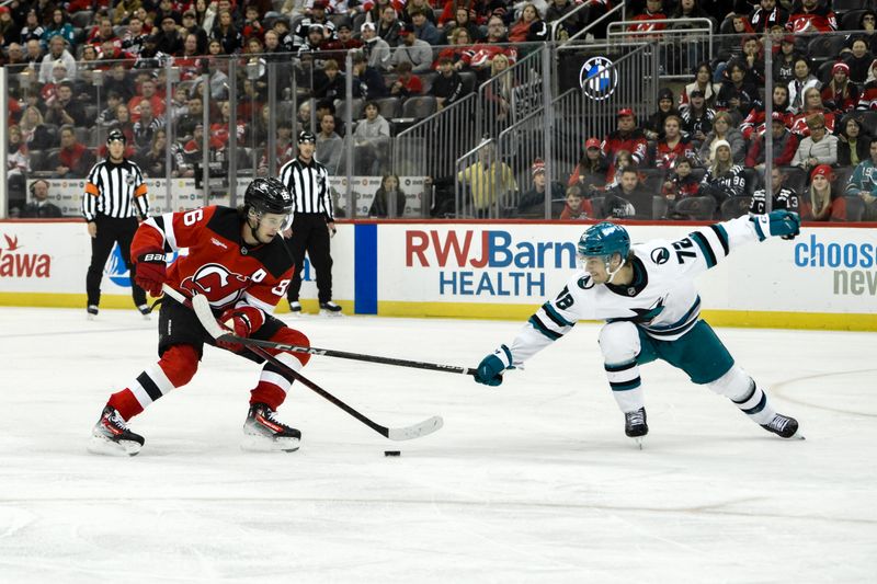 Nov 10, 2024; Newark, New Jersey, USA; New Jersey Devils center Jack Hughes (86) tries to skate past San Jose Sharks left wing William Eklund (72) during the second period at Prudential Center. Mandatory Credit: John Jones-Imagn Images