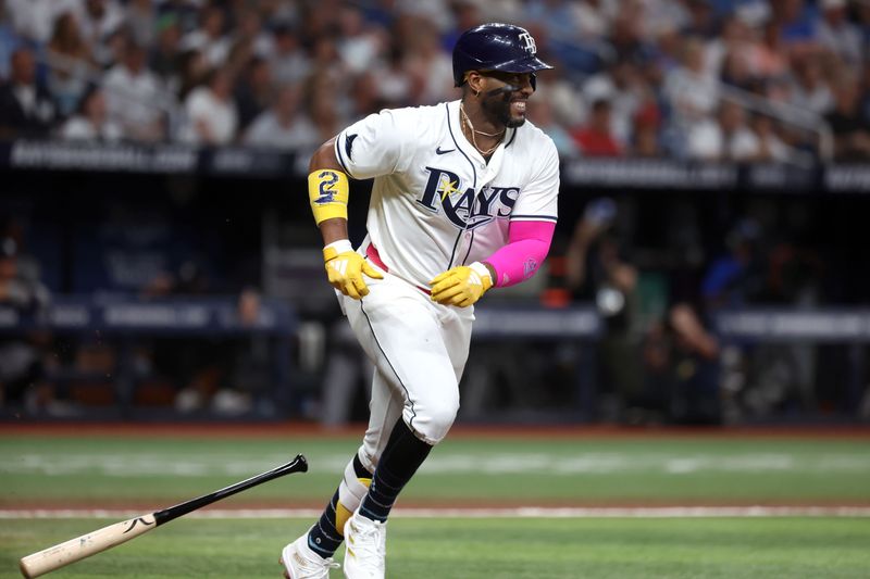 Jul 9, 2024; St. Petersburg, Florida, USA;  Tampa Bay Rays first base Yandy Díaz (2) singles against the New York Yankees during the first inning at Tropicana Field. Mandatory Credit: Kim Klement Neitzel-USA TODAY Sports