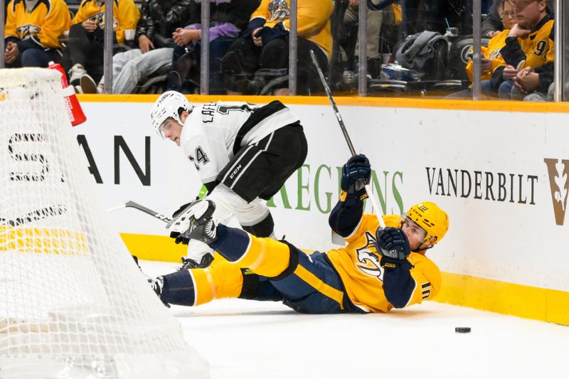 Nov 4, 2024; Nashville, Tennessee, USA;  Los Angeles Kings right wing Alex Laferriere (14) takes down Nashville Predators center Colton Sissons (10) during the second period at Bridgestone Arena. Mandatory Credit: Steve Roberts-Imagn Images