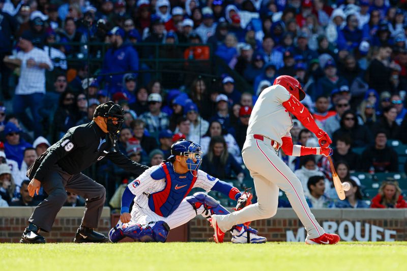 Apr 26, 2025; Chicago, Illinois, USA; Philadelphia Phillies second baseman Bryson Stott (5) hits an RBI-single against the Chicago Cubs during the fourth inning at Wrigley Field. Mandatory Credit: Kamil Krzaczynski-Imagn Images