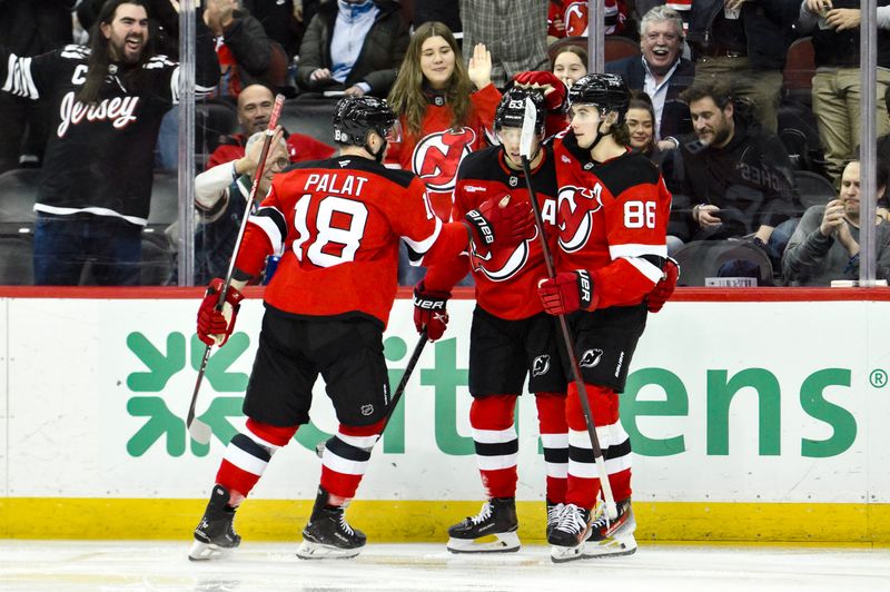 Jan 29, 2025; Newark, New Jersey, USA; New Jersey Devils center Jack Hughes (86) celebrates with teammates after scoring a goal against the Philadelphia Flyers during the third period at Prudential Center. Mandatory Credit: John Jones-Imagn Images