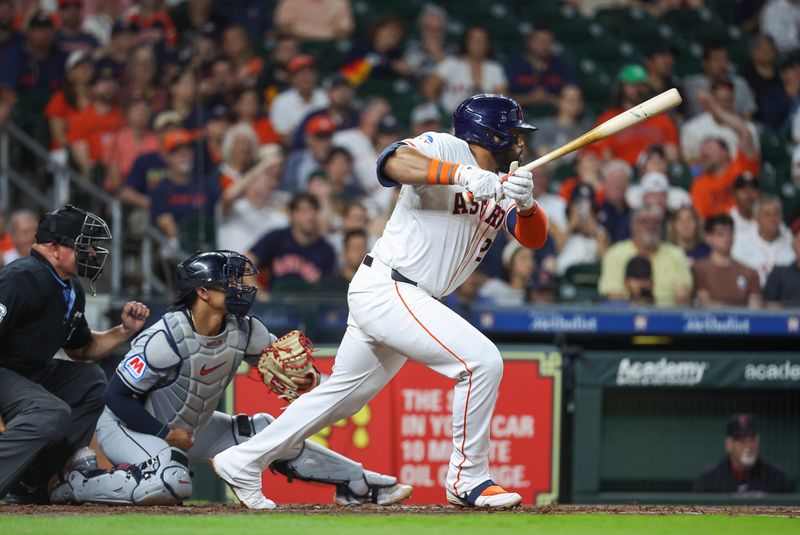 May 2, 2024; Houston, Texas, USA; Houston Astros first baseman Jon Singleton (28) hits an infield single during the third inning against the Cleveland Guardians at Minute Maid Park. Mandatory Credit: Troy Taormina-USA TODAY Sports