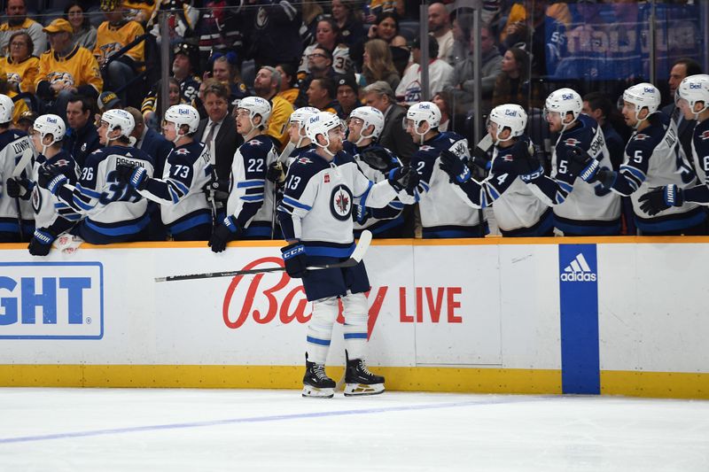 Apr 9, 2024; Nashville, Tennessee, USA; Winnipeg Jets center Gabriel Vilardi (13) is congratulated by teammates after a goal during the first period at Bridgestone Arena. Mandatory Credit: Christopher Hanewinckel-USA TODAY Sports