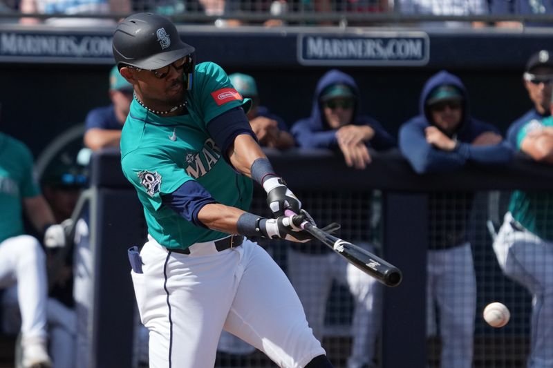 Feb 26, 2026; Peoria, Arizona, USA; Seattle Mariners center fielder Julio Rodríguez (44) hits an RBI double against the Cleveland Guardians in the first inning at Peoria Sports Complex. Mandatory Credit: Rick Scuteri-Imagn Images