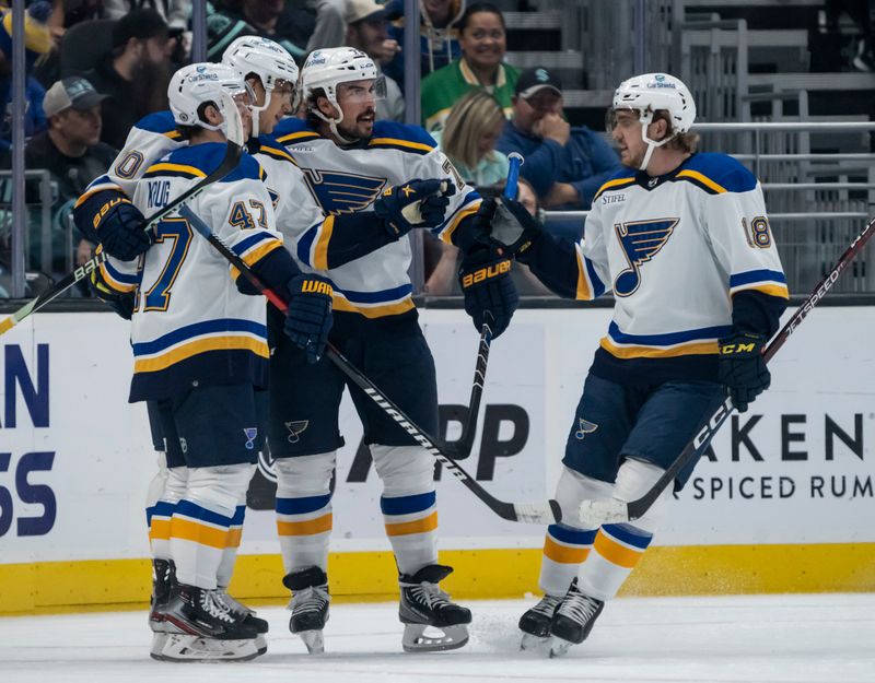 Oct 19, 2022; Seattle, Washington, USA; St. Louis Blues defenseman Torey Krug (47) celebrates his goal with forward Brayden Schenn (10) and defenseman Justin Faulk (72) and forward Robert Thomas (18) during the first period against Seattle Kraken at Climate Pledge Arena. Mandatory Credit: Stephen Brashear-USA TODAY Sports