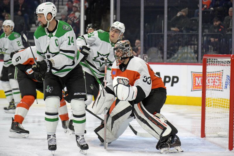 Jan 18, 2024; Philadelphia, Pennsylvania, USA; Philadelphia Flyers goaltender Samuel Ersson (33) battles against Dallas Stars left wing Jamie Benn (14) during the second period at Wells Fargo Center. Mandatory Credit: Eric Hartline-USA TODAY Sports