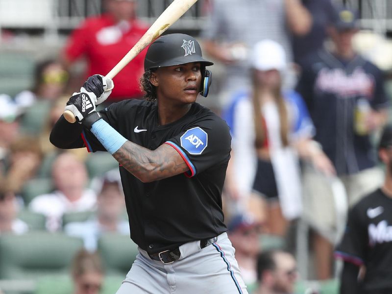 Aug 4, 2024; Cumberland, Georgia, USA; Miami Marlins center fielder Christian Pache (20) at bat in a game against the Atlanta Braves in the fourth inning at Truist Park. Mandatory Credit: Mady Mertens-USA TODAY Sports