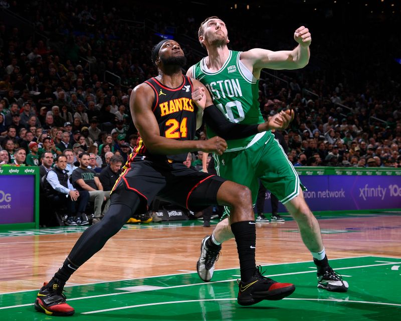 BOSTON, MA - FEBRUARY 7: Bruno Fernando #24 of the Atlanta Hawks and Luke Kornet #40 of the Boston Celtics look to rebound the ball during the game on February 7, 2024 at the TD Garden in Boston, Massachusetts. NOTE TO USER: User expressly acknowledges and agrees that, by downloading and or using this photograph, User is consenting to the terms and conditions of the Getty Images License Agreement. Mandatory Copyright Notice: Copyright 2024 NBAE  (Photo by Brian Babineau/NBAE via Getty Images)