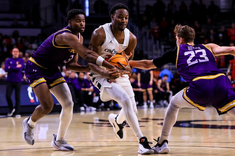 Dec 29, 2025; Cincinnati, Ohio, USA; Cincinnati Bearcats forward Jalen Celestine (32) drives to the basket against Lipscomb Bisons forward Kennedy Okpara (3) and guard Kellan Boylan (23) in the second half at Fifth Third Arena. Mandatory Credit: Katie Stratman-Imagn Images