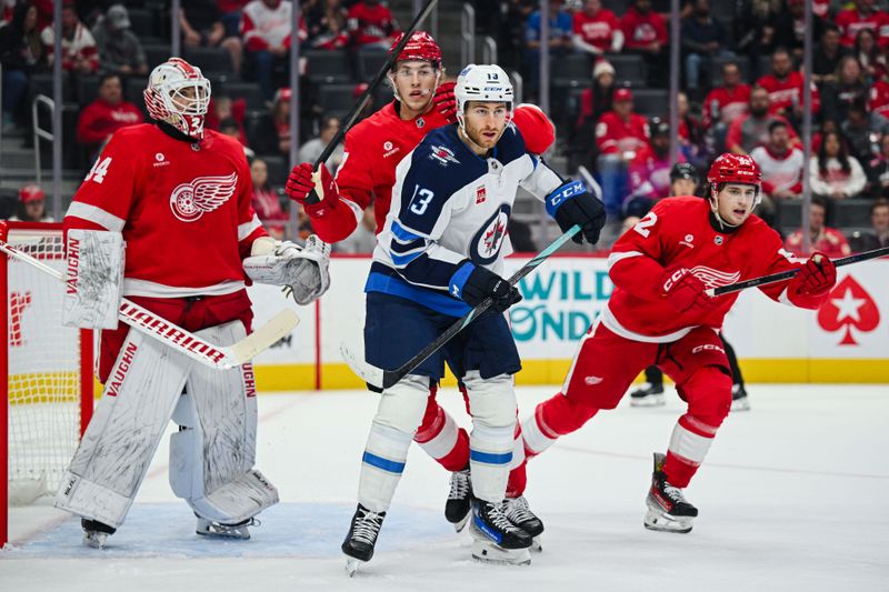 Oct 30, 2024; Detroit, Michigan, USA; Winnipeg Jets center Gabriel Vilardi (13) and Detroit Red Wings defenseman Simon Edvinsson (77) battle for position as goaltender Alex Lyon (34) tends the net during the game at Little Caesars Arena. Mandatory Credit: Tim Fuller-Imagn Images