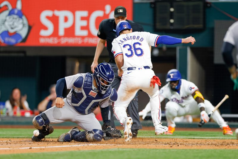 Sep 4, 2024; Arlington, Texas, USA; Texas Rangers outfielder Wyatt Langford (36) avoids the tag by New York Yankees catcher Jose Trevino (39) during the fourth inning at Globe Life Field. Mandatory Credit: Andrew Dieb-Imagn Images