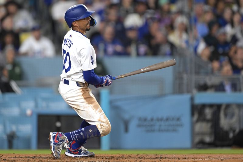 Apr 2, 2024; Los Angeles, California, USA; Los Angeles Dodgers shortstop Mookie Betts (50) watches the flight of the ball on a solo home run for his 1500th career hit in the third inning against the San Francisco Giants at Dodger Stadium. Mandatory Credit: Jayne Kamin-Oncea-USA TODAY Sports