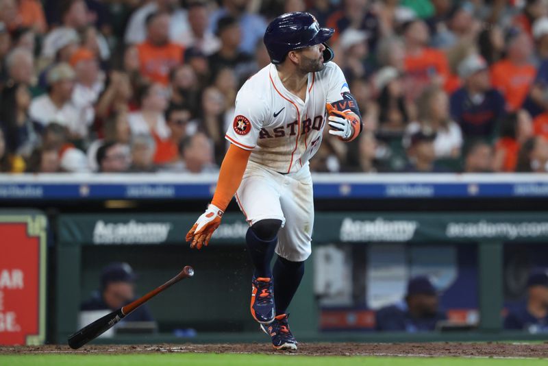 May 31, 2025; Houston, Texas, USA; Houston Astros second baseman Jose Altuve (27) hits a single during the third inning against the Tampa Bay Rays at Daikin Park. Mandatory Credit: Troy Taormina-Imagn Images